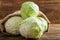 Sack with fresh cabbages on wooden table