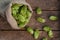 Sack and fresh green hops on wooden table, flat lay