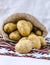 Sack organic potatoes on the Ukrainian towel