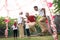 Sack race participants jumped each other by jumping to quickly reach the finish line