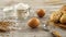 Sack of wheat, flour, garlic, eggs, and fresh bread on a rustic wooden table.