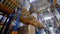 Sacks and boxes rest on warehouse racks in a low view.