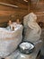 Sacks of flour on wooden bench in barn