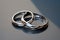 Sacrament: Matrimony. Wedding rings on a reflective surface