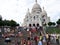 Sacre Coeur Basilica in summer day. A lot of tourists sitting on the stairs. Large medieval cathedral. August 05, 2009, Paris,