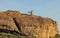 Sacred baobab is landmark on rocky cliff above the savannah in Botswana