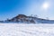 Sacred Cape Burkhan on Olkhon Island in winter. View from the ice of frozen Lake Baikal on a sunny day