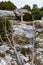 The sacred cross St.Pilon is on the mountain in cloudy weather, clouds over a valley, a dry grass, mountain over grotto