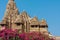 Sacred Hindu temple and walking prayers in Khajuraho, India. Ancient design and towers of the 10th century indian temple