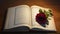 the Sacred Scriptures of the Koran and a red rose placed on the open book