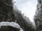 A sacred small column with colored ribbons in a gorge covered with snow in Abkhazia in winter