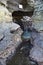 Sacred spring in rock at Hindu temple Tanah Lot