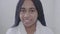 Sad African American woman with dreadlocks looking at camera and smiling. Cute teen in white bathrobe posing. Beauty