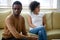 Sad angry african married couple ignoring each other after quarrel