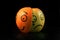 Sad apple with happy orange mask