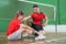 Sad asian female badminton player sitting on court