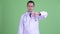 Sad Asian man doctor with eyeglasses giving thumbs down