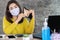 Sad Asian woman wearing protective mask hand open empty purse having financial problem during self-quarantine from covid-19 virus