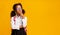 Sad Black Schoolgirl Thinking Touching Chin Over Yellow Background