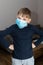 Sad boy in coronavirus quarantine at home in blue medical mask. epidemic control of coronavirus. Unhappy