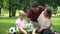 Sad boy sitting lonely in park, parents give him gift to support and cheer up