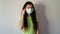 A sad brunette woman removes her medical mask. Respiratory protection during flu, infections, and epidemics