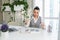 Sad business woman sits at work desk in front of laptop and counts cash. Concept of low salary