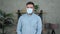 Sad businessman wears protective medical mask on face turns head looking camera