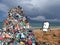 Sad Cartoon man Standing by a Big pile of Garbage, on Beach photo