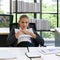 Sad Caucasian businesswoman losing job, sitting on the table in the office. The concept of unemployed, sadness, depressed and