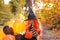 Sad Child in a carnival costume on Halloween with large colored balloons. Little girl in the autumn park. The focus is