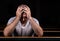 A Sad Christian man in white shirt is sitting and praying with humble heart in the church