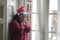 Sad Christmas home alone during covid19 - young beautiful and depressed Asian Korean woman in Santa Claus hat looking melancholic
