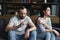 sad couple sitting on sofa at home after quarrel