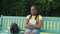 Sad depressed black female student sitting on bench after failed exam