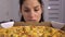 Sad dieting woman looking at pizza. Eating disorder concept. Loosing weight.
