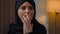 Sad disappointed upset crying arabian muslim arabian woman multiracial girl lady sit indoors home apartment anxious