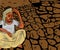 Sad farmer sitting at drought prone Agriculture farm land - concept showing of drought conditions india
