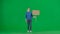 A sad female activist holds a blank sign on a green screen. Chroma key, advertisement, promo.