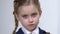 Sad female pupil taking off eyeglasses, little schoolgirl insecurities, bullying