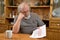 Sad and frustrated old man reading eviction notice