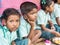 Sad girl teenagers pupils being served Meal plate of rice In government School Canteen. Unhealthy food for poor children