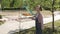 A sad girl walks near a closed Playground because of the quarantine. The children`s Playground is fenced with a