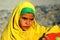 Sad girl with a yellow scarf in the desert.Bedouin village .