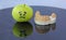 Sad green apple crying next to plaster model of lower teeth