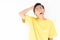 Sad Indonesian guy with a yellow t-shirt struggling with a headache on a white background