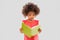 Sad little african american girl reading book