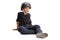 Sad little boy with helmet sitting on the floor