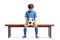 Sad little footballer seated on a wooden bench