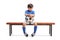 Sad little footballer sitting on a wooden bench